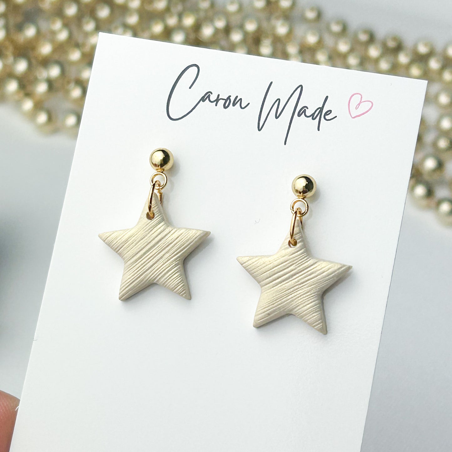 Small light gold star earrings
