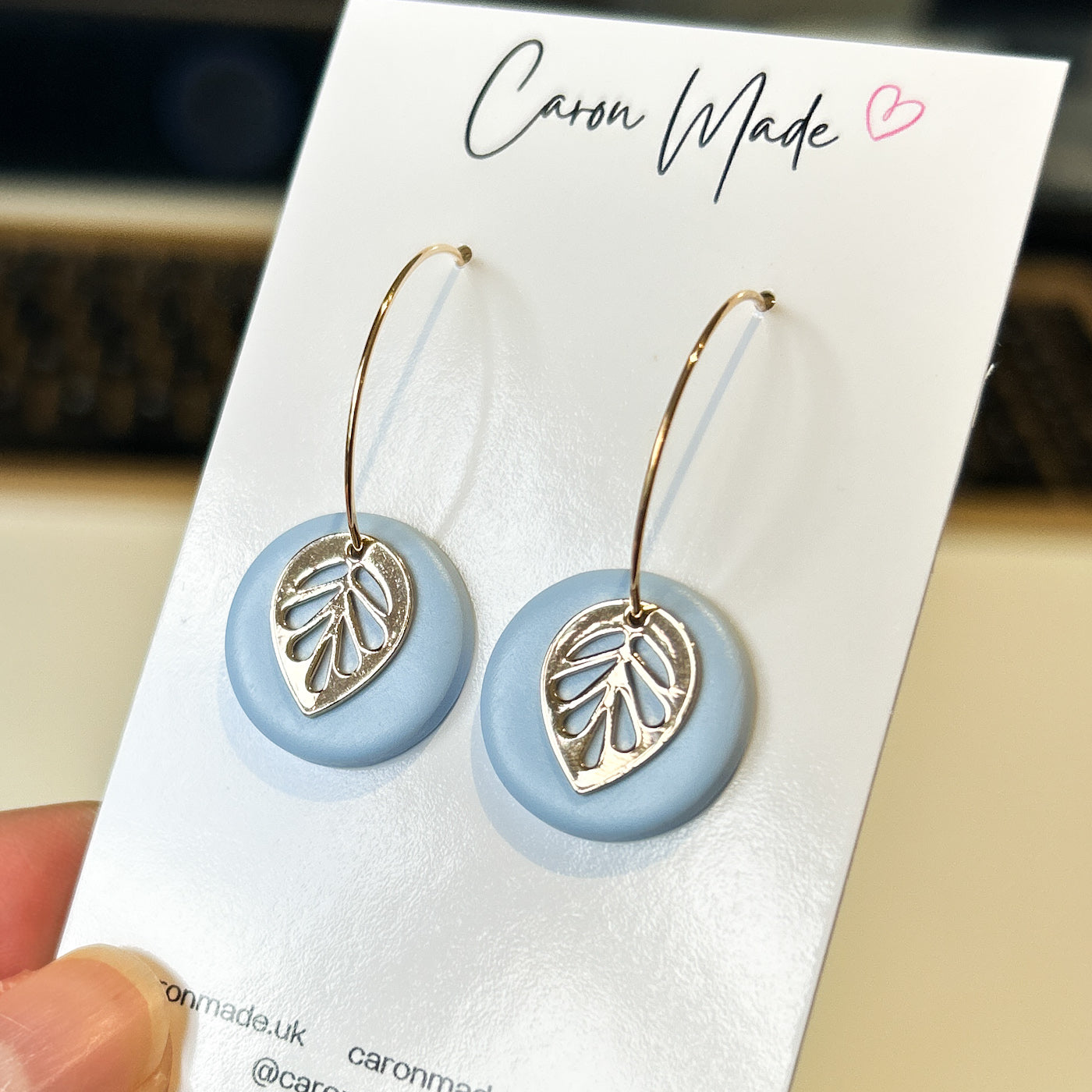 Hoop earrings with blue clay and leaf charm