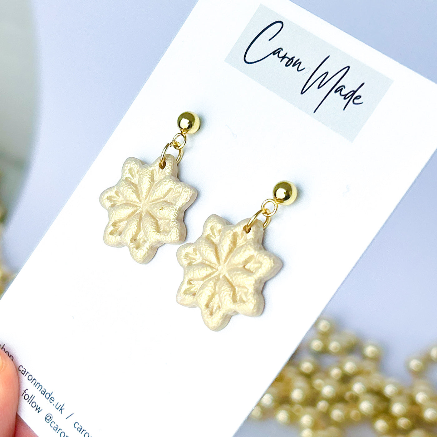Light gold and beige snowflake dangle earrings