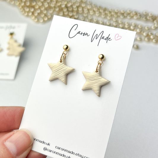 Small light gold star earrings