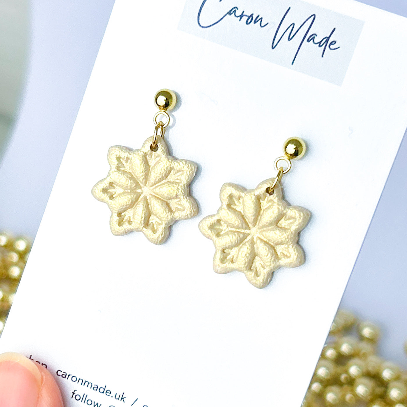 Light gold and beige snowflake dangle earrings