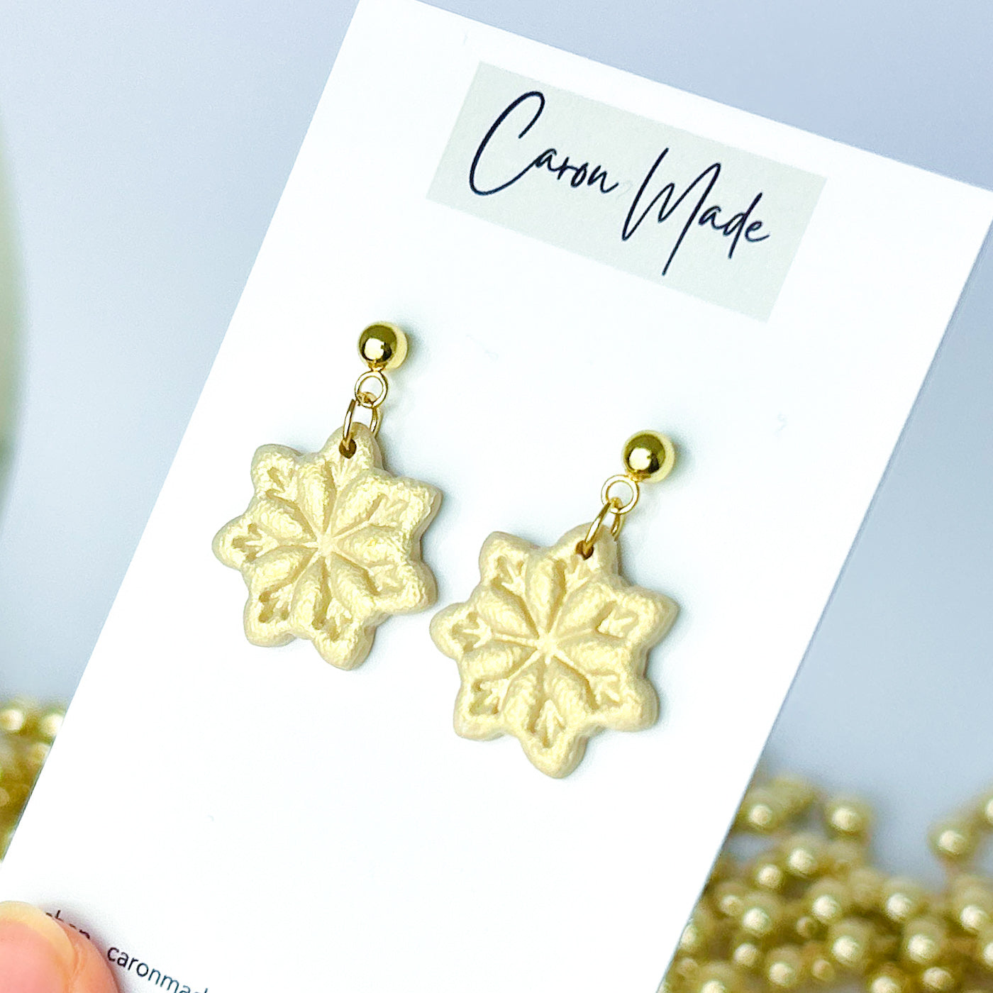 Light gold and beige snowflake dangle earrings